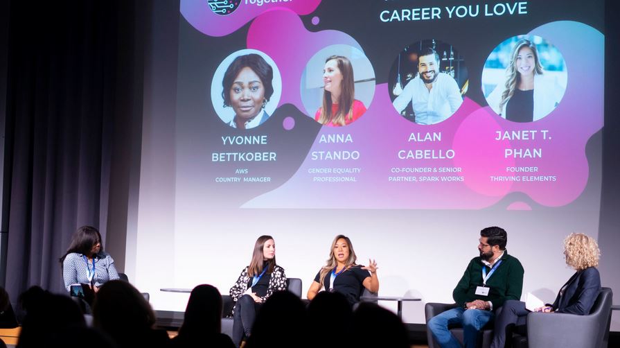 image of people sitting on a conference stage