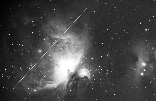 photo of Orion Nebula (M42) with a satellite trail